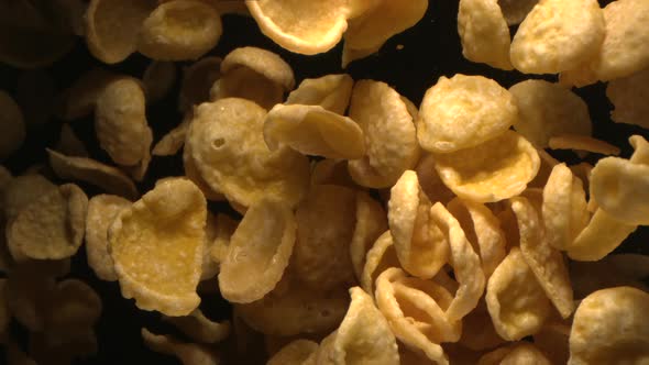 Breakfast Corn Flakes Flying In The Air In Slow Motion On Black Background 4K alt