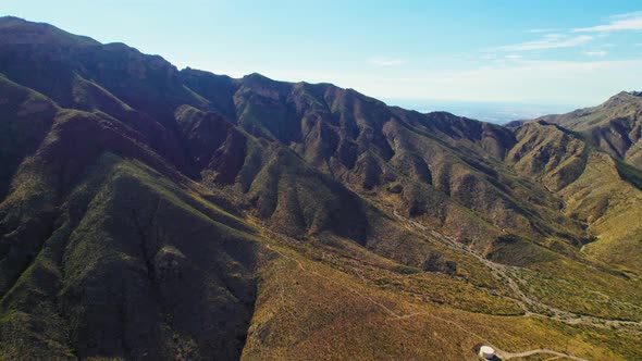 Aerial Drone Shot Of Beautiful Summer Desert Mountain Range Covered In Green Foliage Near Famous US alt