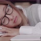 Schoolgirl with Glasses Learns Lessons Cute Girl Sleeping in Library While Doing Homework