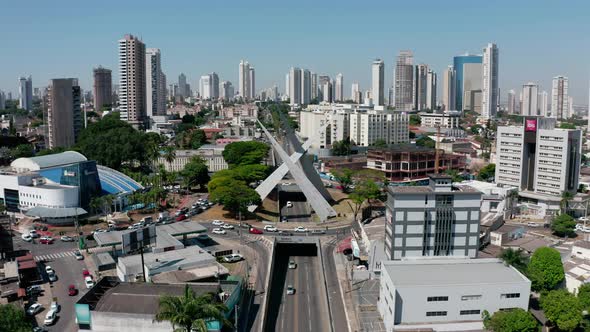 Aerial shot of the streets of Goiania in Brazil with many skyscrapers in the horizon. alt