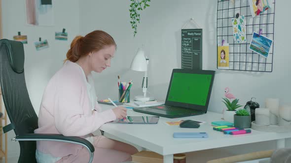 Female Designer Draws a Sketch on a Tablet Pc alt