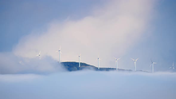 Wind Turbines Farm in Foggy Landscape