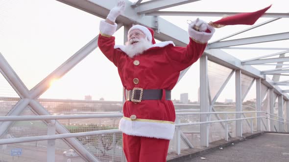 Santa Claus dancing on a pedestrian walkway. Merry Christmas.