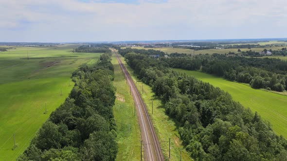 Railroad Through green grassed countryside, Aerial alt