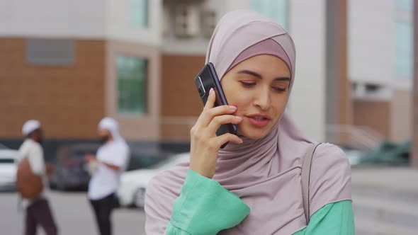 Muslim Woman Talking on Smartphone alt