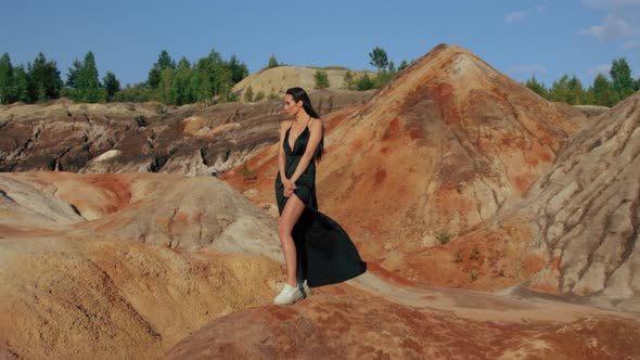 Beautiful woman posing on other-worldly hilly landscape