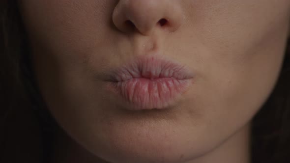 Close Up of a Caucasian Woman Lips Doing a Kiss and a Smile in Slow Motion alt