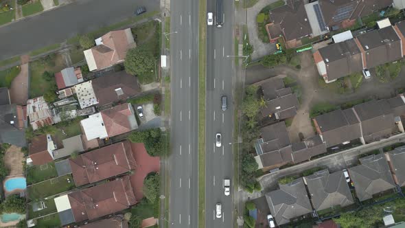 4K aerial dual carriageway or divided highway among the neighborhood homes, houses and properties wi alt