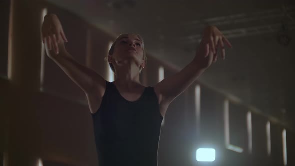 Middle Plan Slow Motion a Young Ballerina Girl Performs Graceful Movements on the Stage in a Tutu alt