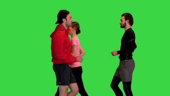 Many Different Sporty People Walking in Front of the Camera on a Green Screen Chroma Key
