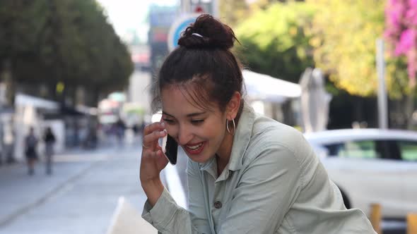 Young Entrepreneur making a call while smiling and happy about news, young women in business