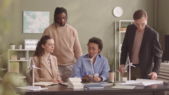 Diverse Team of Colleagues Discussing Project of Renewable Energy alt