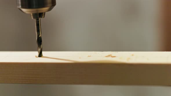 Twist Drill Drills Thru a Wooden Plank Closeup in Slomo