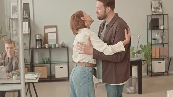 Man and Woman Greeting in Office alt