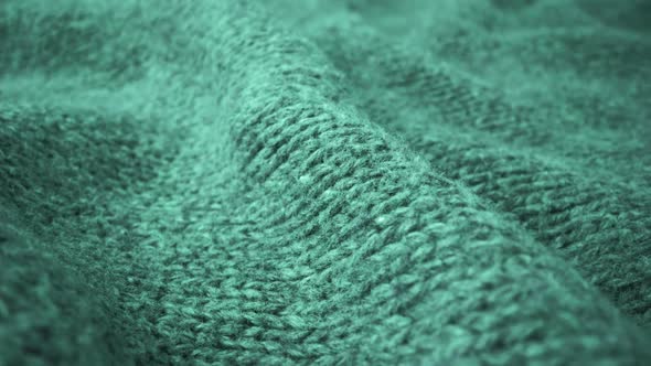 Extreme detail view of sheep wool cloth texture flowing in macro dolly shot. alt