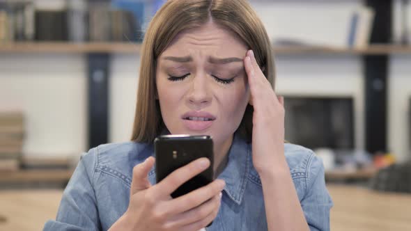 Creative Woman Reacting To Loss While Using Smartphone alt