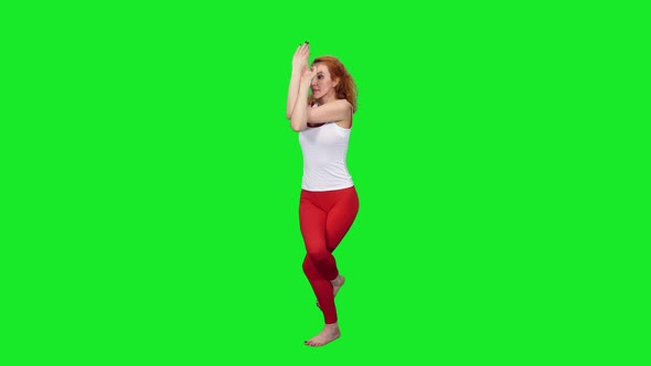 Slim Sporty Woman Standing In Yoga Pose On Green Screen Background