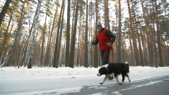 Man Running with Dog on Winter Day alt