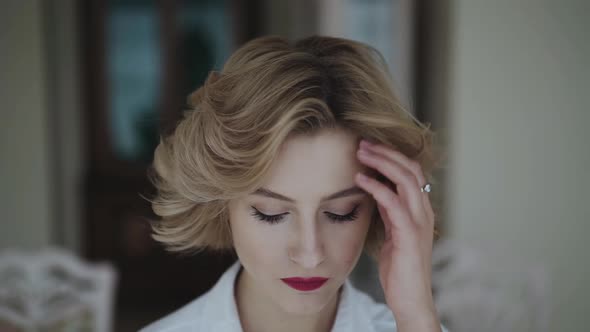 Close Portrait of Woman Opening Eyes and Looking with Smile at Camera alt