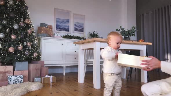 Mother's Christmas Mood with Her Child, Near the New Year Tree. Winter Holidays. alt