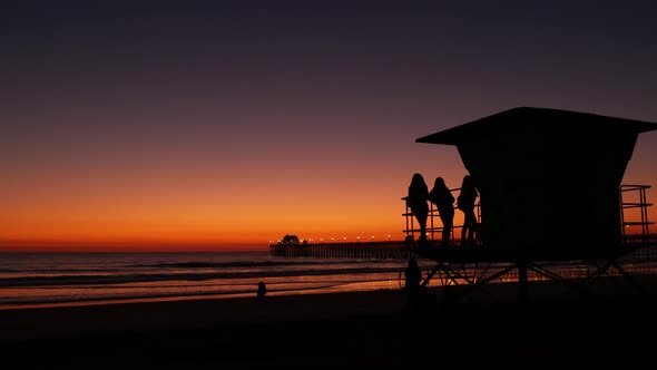 Young Teen Girls Silhouettes Lifeguard Watch Tower Friends on Pacific Ocean Beach California USA