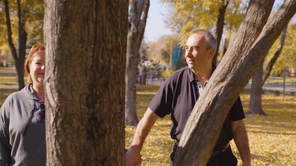 Loving Old Couple Walking Talking Outdoors in Park alt
