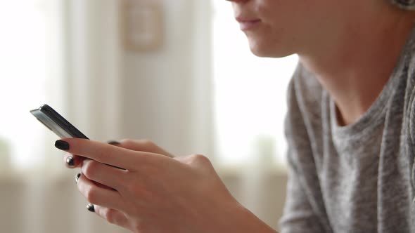 Close Up Female Hands Typing Message on Smartphone Part of Smiling Woman Face Enjoy Distant alt