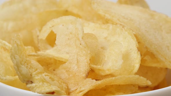 Thin slice potato chips in a bowl popular snack slow tilt 4K 3840X2160 UltraHD footage - Deep fied s alt