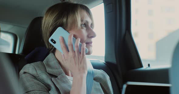 Beautiful Businesswoman Talking on the Phone in Car Working on Laptop alt