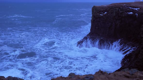 Rough Ocean Water Crashes against Large Cliffs in Arnarstapi in Iceland