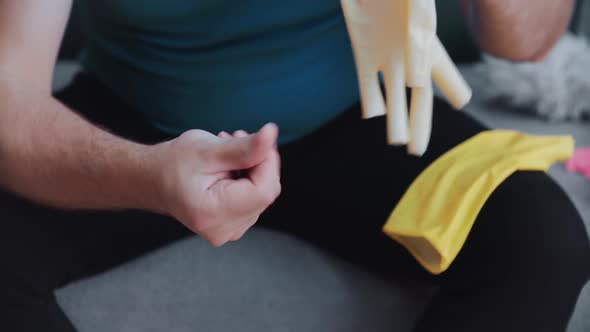 The Man Takes Off His Rubber Gloves