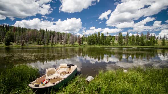 Time-lapse video in the Uinta Mountains with a boat  on the edge of a lake. alt