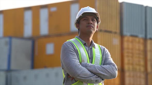 Worker man checking and control loading containers box from cargo