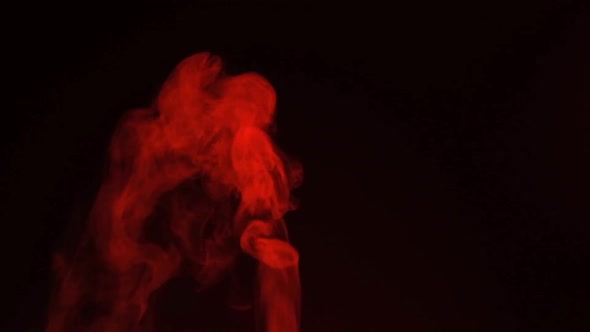 Slow motion of red smoke, fog, mist, vapor on a black background. alt