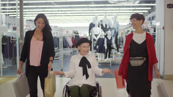 Excited Disabled Woman and her Female Friends in Shopping Mall alt