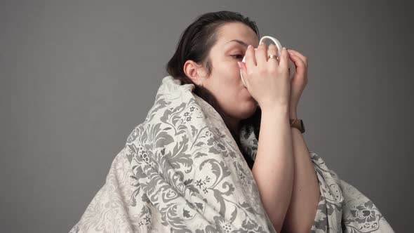 Portrait of Sick Tired Woman Patient with White Cup Sitting on Sofa