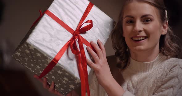 Happy Woman Unboxing Christmas Gift alt