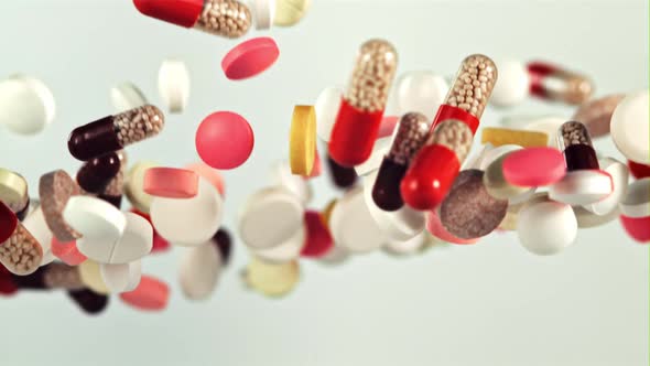 A Bunch of Different Pills Fly Up and Fall Down alt