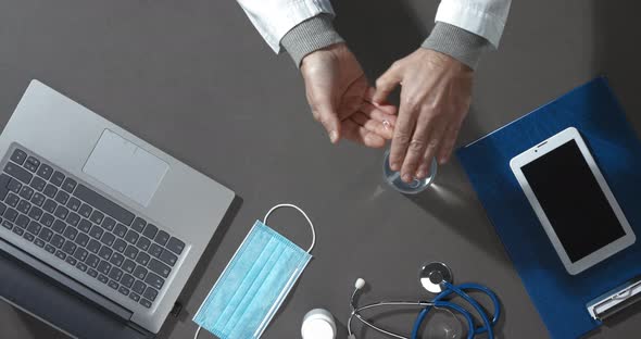 Doctor applying sanitizer on his hands