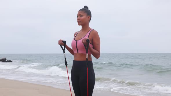 Mixed ethnicity woman exercising at the beach alt
