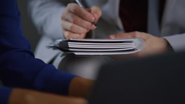 Businessman Hand Writing Notebook Working at Corporate Meeting Office Workplace alt