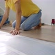 A Family of Woman and Man Install Laminate on the Floor in Their Apartment - VideoHive Item for Sale