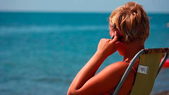 Woman Talking On the Phone At the Beach