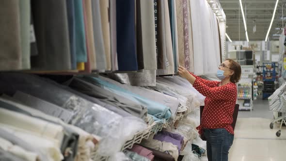 Senior Woman Shopping for Curtains in a Store alt