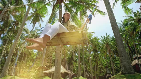 Concept: Enjoyment, Happiness and Freedom. Freedom Woman. Travel Concept. Girl Having Fun Swinging alt