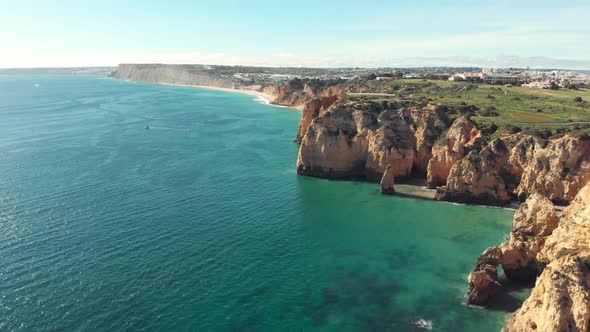 Panoramic view sea, coast and cliffs of Lagos in Algarve, Portugal. Aerial forward alt