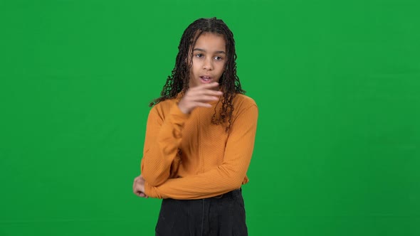 Irritated Bored Teenage Girl Rolling Eyes Gesturing Saying Blabla on Green Screen alt