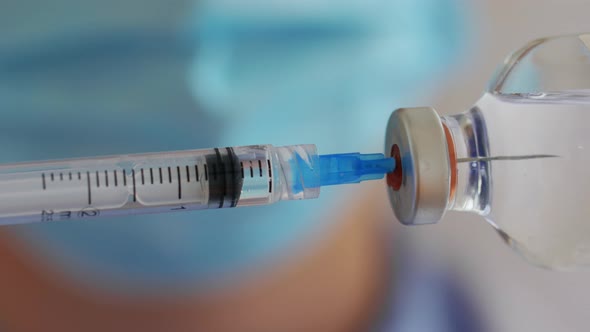 Close Up of Syringe Filling with Medicine