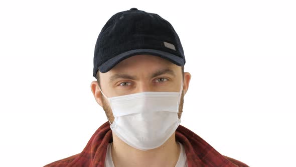 Caucasian Man Wearing a Protection Mask Making Ok Sign on White Background. alt
