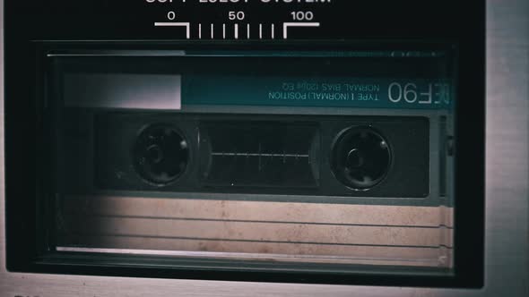 Audio Cassette Tape Rotates in Deck of an Old Tape Recorder alt